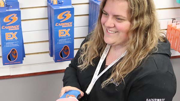 Sanford Equip worker assists with a shoe orthotic fitting