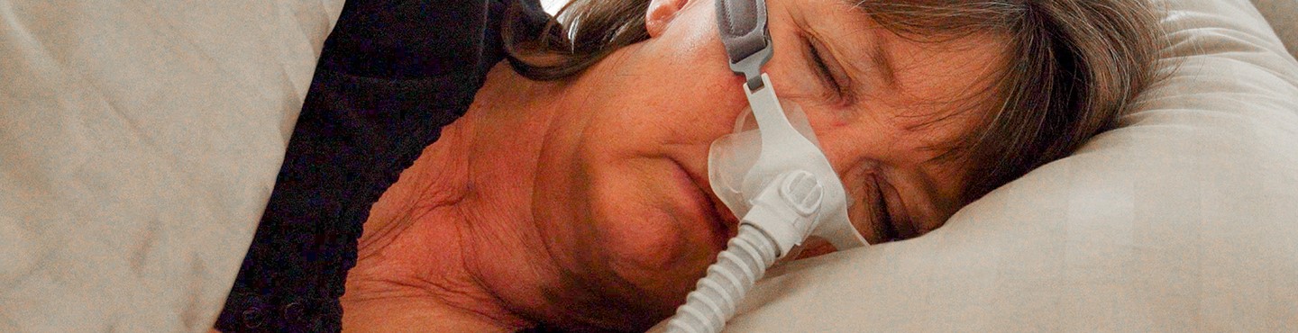 person sleeping with CPAP machine