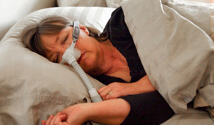 Woman sleeping on her side with a cpap machine