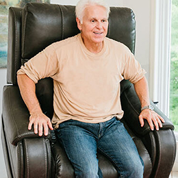 Person getting into a brown lift chair