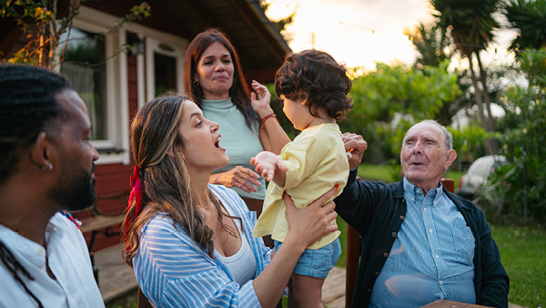 A family outdoors celebrating a young child